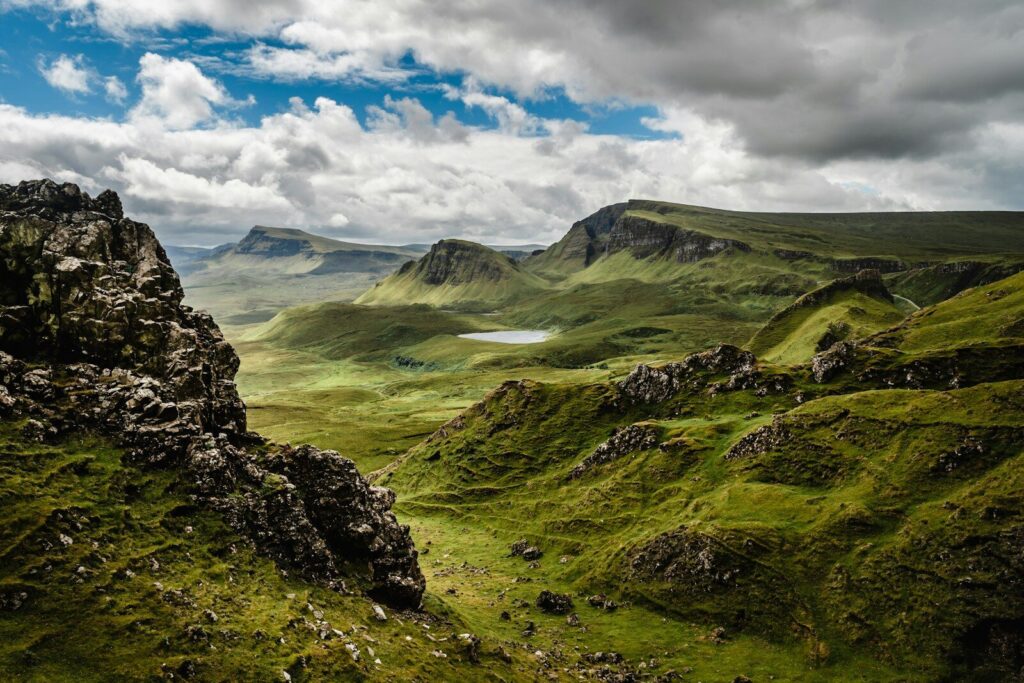 Green grass on a mountain under a cloudy sky
